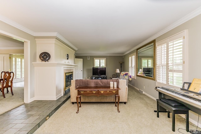 8804 W Tulip Tree Dr, Muncie, IN 47304 - living room with a glass covered fireplace, crown molding, light carpet, and baseboards