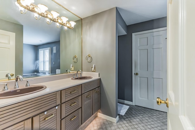 8804 W Tulip Tree Dr, Muncie, IN 47304 - bathroom with double vanity, tile patterned flooring, and baseboards