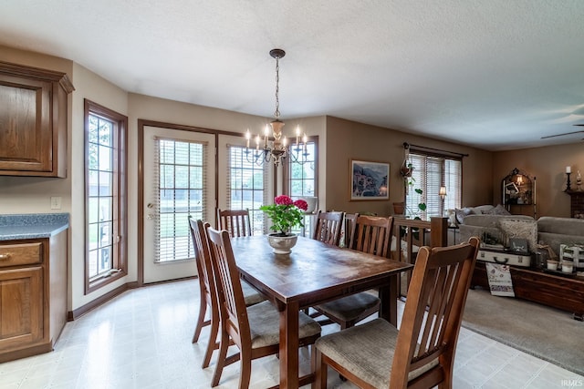 15329 Laurel Ridge Pl, Leo, IN 46765 - dining area with a chandelier, light floors, and a textured ceiling