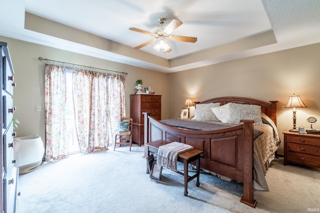15329 Laurel Ridge Pl, Leo, IN 46765 - bedroom with light colored carpet, a raised ceiling, and ceiling fan