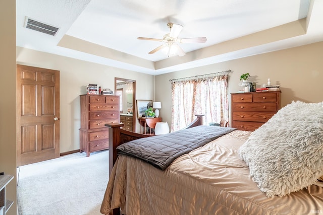 15329 Laurel Ridge Pl, Leo, IN 46765 - bedroom featuring light colored carpet, a tray ceiling, a ceiling fan, and ensuite bathroom