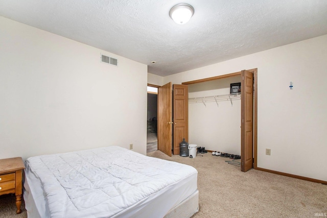 1849 N Meade St, South Bend, IN 46628 - bedroom with light colored carpet, a closet, a textured ceiling, and baseboards