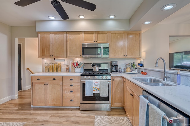 713 Carole Pl, Newburgh, IN 47630 - kitchen with stainless steel appliances, a sink, ceiling fan, light countertops, and light brown cabinetry