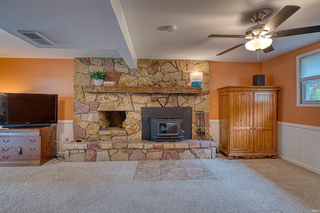 713 Carole Pl, Newburgh, IN 47630 - living room with a wood stove, carpet floors, a ceiling fan, and wainscoting