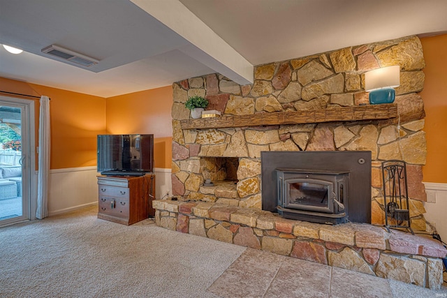 713 Carole Pl, Newburgh, IN 47630 - unfurnished living room with a wood stove, wainscoting, and carpet floors