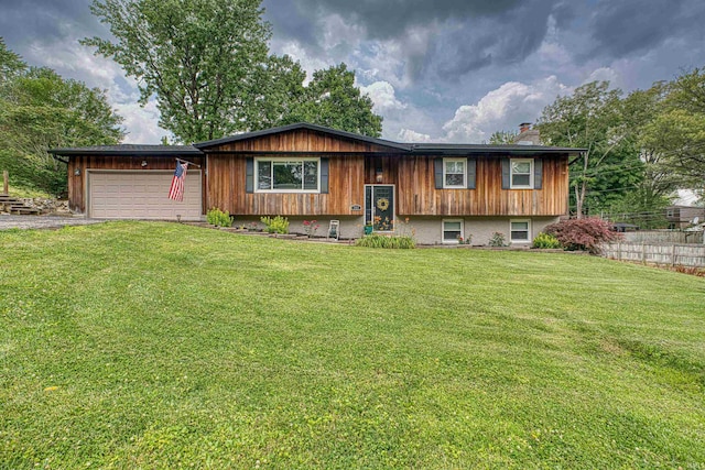 713 Carole Pl, Newburgh, IN 47630 - bi-level home featuring a chimney, an attached garage, and asphalt driveway