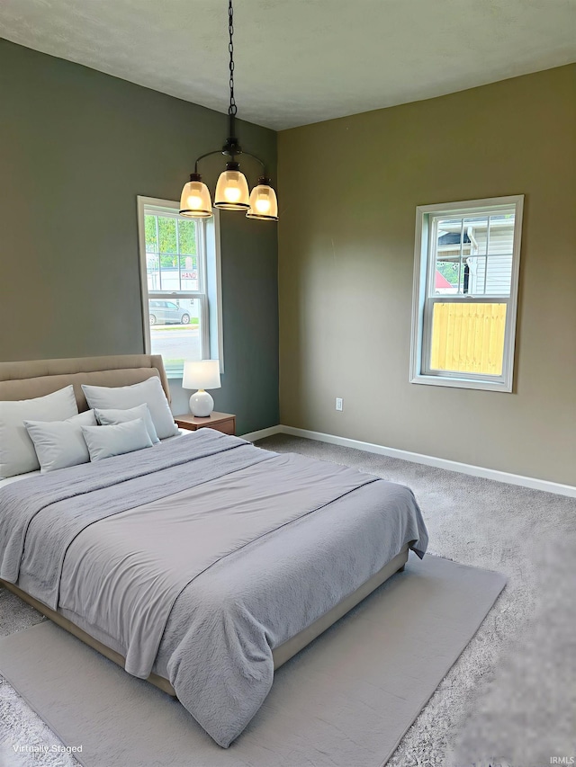 406 W N St, Kokomo, IN 46901 - bedroom with baseboards, a chandelier, and carpet floors