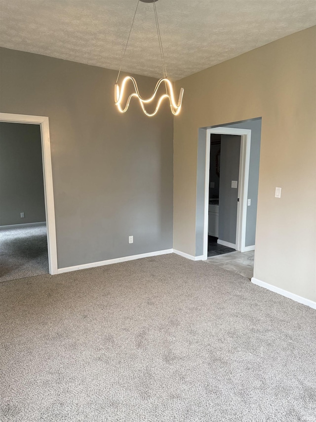 406 W N St, Kokomo, IN 46901 - carpeted spare room with a chandelier, a textured ceiling, and baseboards