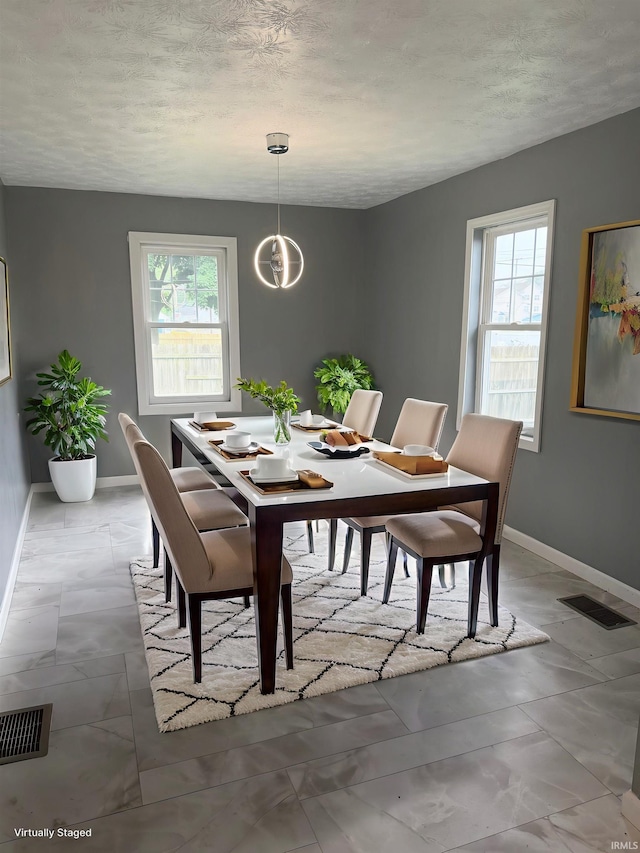 406 W N St, Kokomo, IN 46901 - dining room featuring baseboards and a textured ceiling