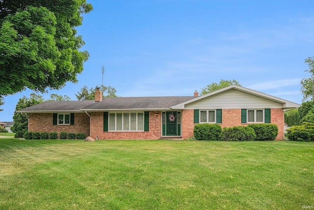 26966 Heather Ln, Elkhart, IN 46514 - ranch-style house with brick siding, a front lawn, and a chimney