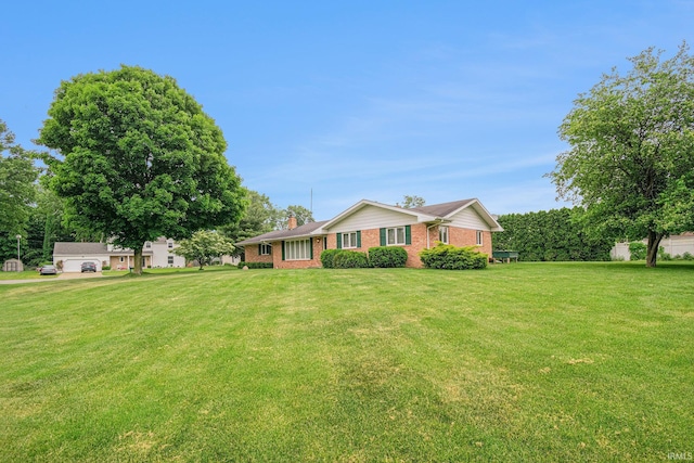 26966 Heather Ln, Elkhart, IN 46514 - ranch-style house with brick siding, a front yard, and a chimney