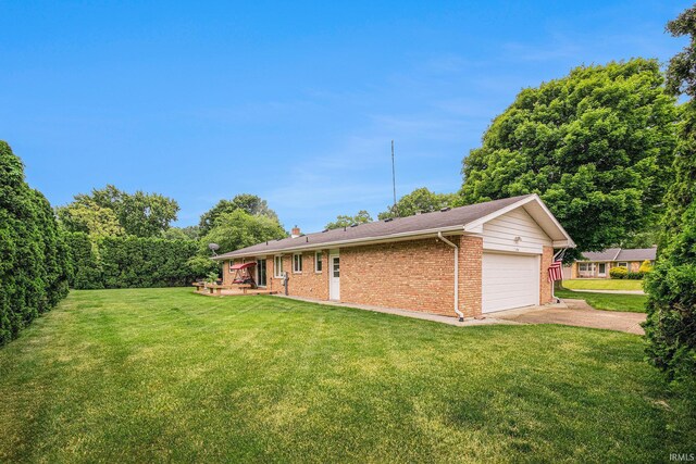 26966 Heather Ln, Elkhart, IN 46514 - view of grassy yard featuring driveway and an attached garage