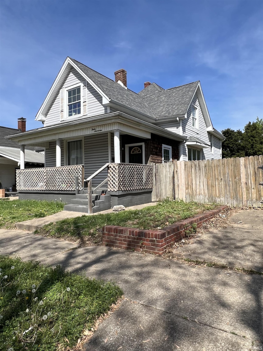 1217 Edgar St, Evansville, IN 47710 - view of front of property with a porch, a chimney, and roof with shingles