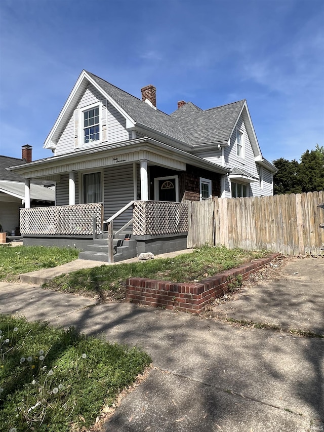 1217 Edgar St, Evansville, IN 47710 - view of front of property with a porch, a chimney, and roof with shingles
