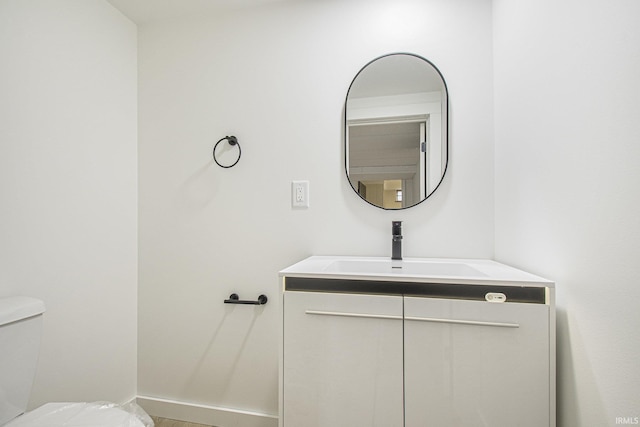 519 W 12th St, Mishawaka, IN 46544 - half bathroom featuring vanity, toilet, and baseboards