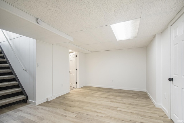519 W 12th St, Mishawaka, IN 46544 - finished below grade area featuring wood finished floors, a drop ceiling, stairway, and baseboards