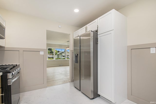 519 W 12th St, Mishawaka, IN 46544 - kitchen featuring appliances with stainless steel finishes, white cabinetry, and recessed lighting
