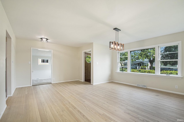 519 W 12th St, Mishawaka, IN 46544 - unfurnished room with light wood-style flooring, a chandelier, and baseboards