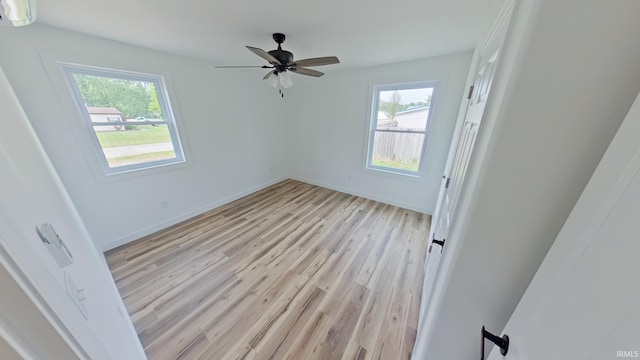 30050 Wren St, Elkhart, IN 46517 - unfurnished bedroom with multiple windows, light wood-type flooring, an AC wall unit, and baseboards
