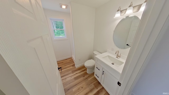 30050 Wren St, Elkhart, IN 46517 - bathroom featuring vanity, toilet, wood finished floors, and baseboards