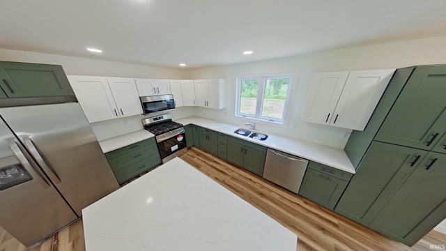 30050 Wren St, Elkhart, IN 46517 - kitchen with green cabinetry, appliances with stainless steel finishes, light wood-type flooring, white cabinets, and a sink