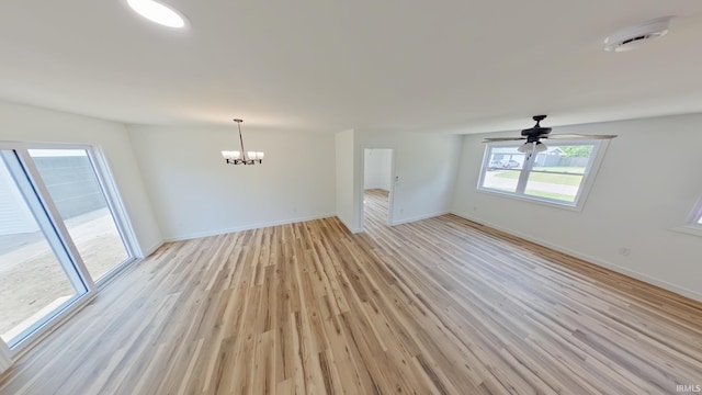 30050 Wren St, Elkhart, IN 46517 - unfurnished living room featuring a chandelier, light wood finished floors, baseboards, and a ceiling fan