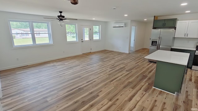 30050 Wren St, Elkhart, IN 46517 - kitchen with a wall mounted AC, open floor plan, light wood finished floors, recessed lighting, and baseboards