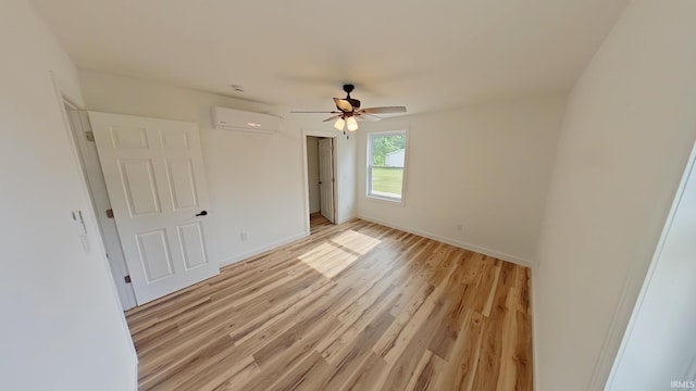 30050 Wren St, Elkhart, IN 46517 - unfurnished bedroom featuring a wall mounted AC, light wood-style flooring, baseboards, and ceiling fan
