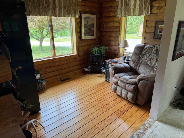 1764 County Road 66th Rd, Auburn, IN 46706 - living area featuring rustic walls, hardwood / wood-style flooring, and a wood stove