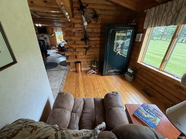 1764 County Road 66th Rd, Auburn, IN 46706 - living area with wood-type flooring, beam ceiling, log walls, and a fireplace