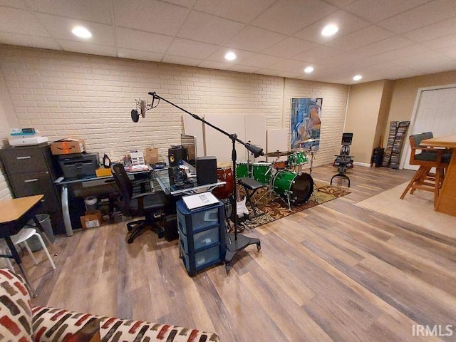 394 Saint Charles St, Jasper, IN 47546 - office area featuring wood finished floors, brick wall, and a paneled ceiling