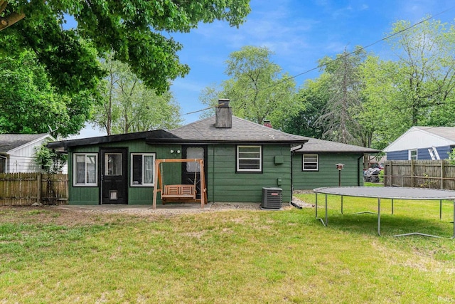 332 W Tyland Blvd, New Haven, IN 46774 - rear view of property featuring a trampoline, central AC, and a chimney