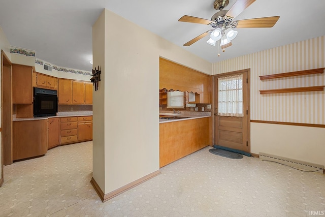 14 Brady Ct, Lafayette, IN 47909 - kitchen with black oven, brown cabinets, a baseboard radiator, ceiling fan, and backsplash