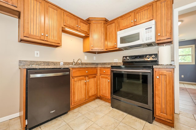 17111 Antwerp Rd, Harlan, IN 46743 - kitchen featuring dishwasher, electric range, white microwave, and light tile patterned floors