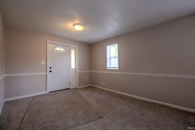 400 S Main St, Knox, IN 46534 - foyer entrance with carpet floors, a textured ceiling, and baseboards