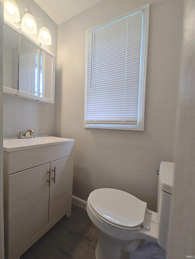 400 S Main St, Knox, IN 46534 - bathroom featuring toilet, wood finished floors, vanity, and baseboards
