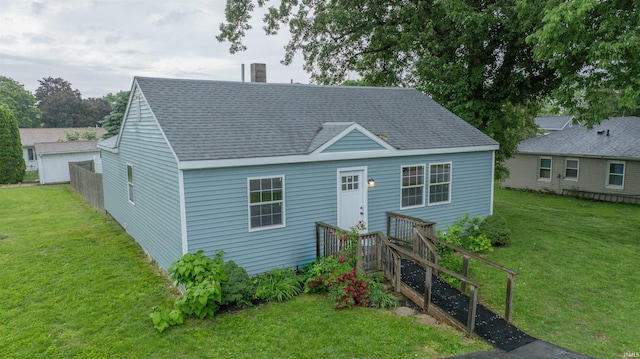 1109 E 6th St, Fowler, IN 47944 - view of front of home with a shingled roof, a front yard, and a chimney