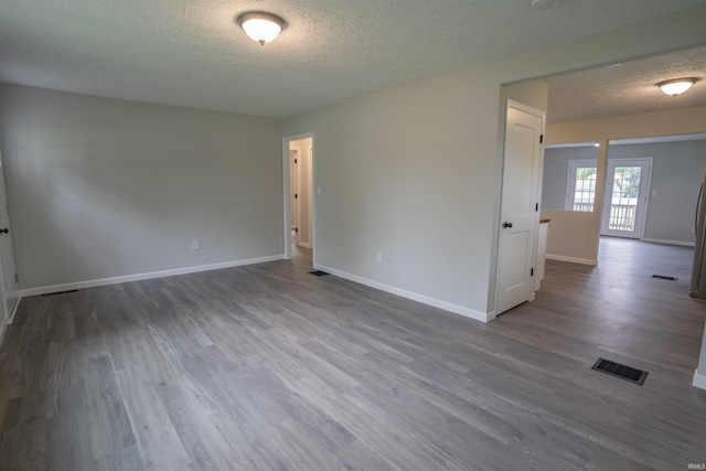 1109 E 6th St, Fowler, IN 47944 - unfurnished room with a textured ceiling, wood finished floors, and baseboards