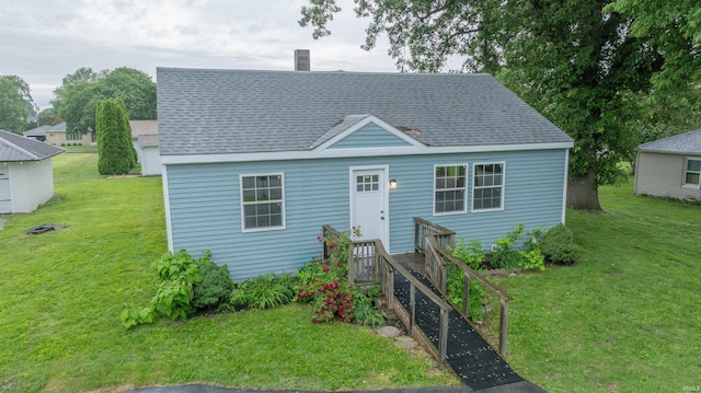 1109 E 6th St, Fowler, IN 47944 - view of front of home with roof with shingles, a front lawn, and a chimney