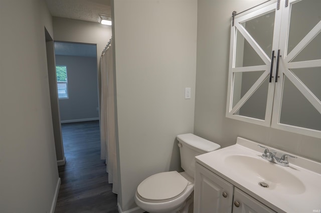 1109 E 6th St, Fowler, IN 47944 - full bath featuring toilet, vanity, wood finished floors, and baseboards