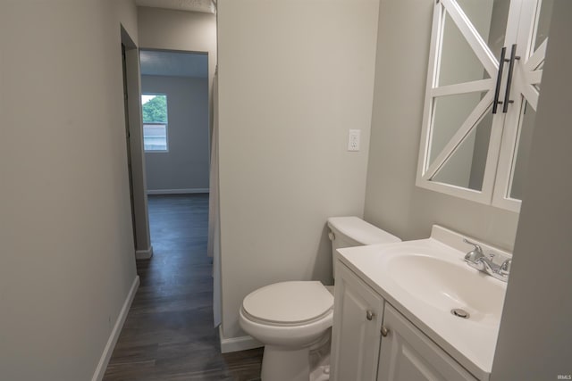 1109 E 6th St, Fowler, IN 47944 - half bath with toilet, wood finished floors, vanity, and baseboards