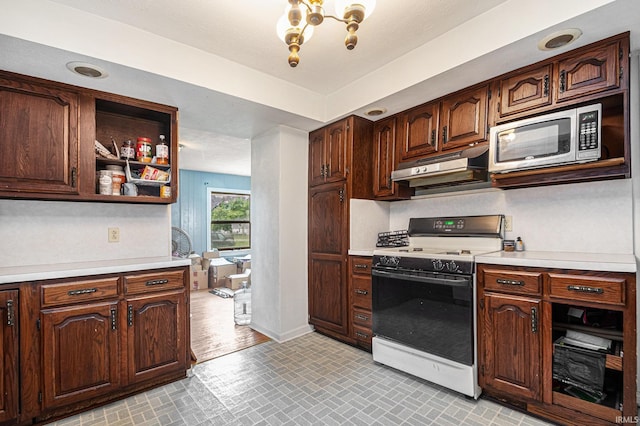 56687 Lake St, Osceola, IN 46561 - kitchen with white range with gas stovetop, stainless steel microwave, under cabinet range hood, light countertops, and baseboards