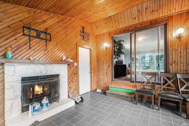 56687 Lake St, Osceola, IN 46561 - tiled living area featuring wood walls, lofted ceiling, wooden ceiling, and a stone fireplace