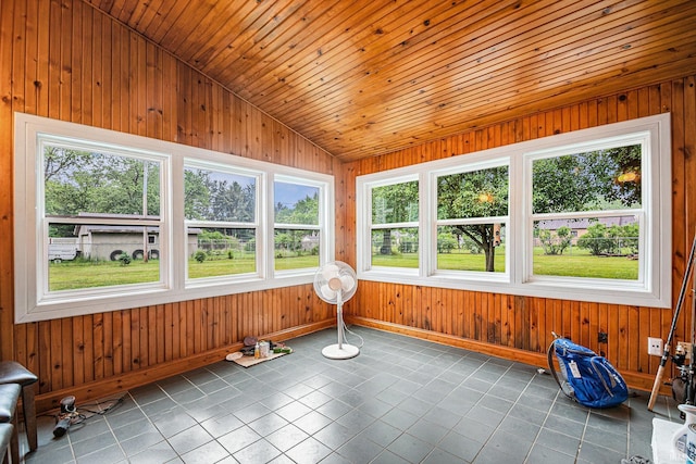 56687 Lake St, Osceola, IN 46561 - unfurnished sunroom featuring lofted ceiling, baseboards, wooden walls, and tile patterned floors