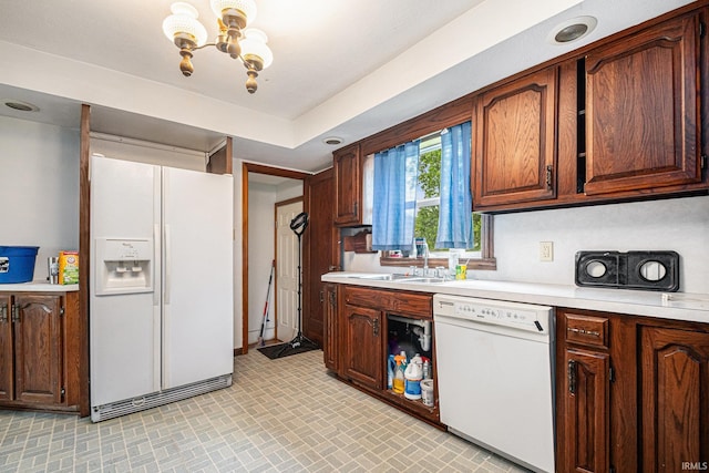 56687 Lake St, Osceola, IN 46561 - kitchen featuring white appliances, a chandelier, light countertops, and a sink