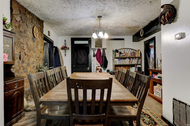 9469 W Sinclair Rd, Birdseye, IN 47513 - dining area with a textured ceiling, a chandelier, and carpet flooring