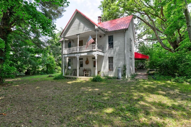 9469 W Sinclair Rd, Birdseye, IN 47513 - back of house with a balcony, a porch, a chimney, and metal roof