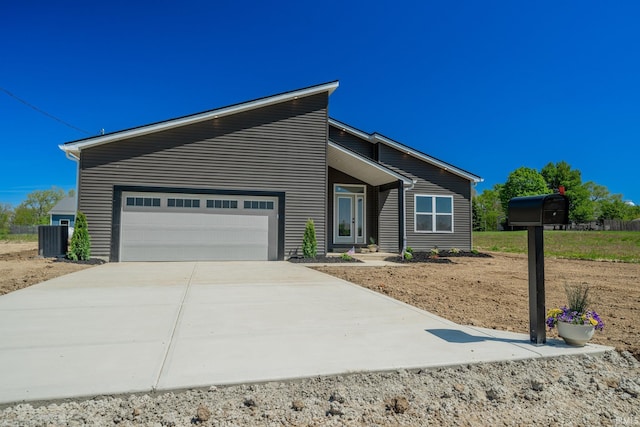 848 W S St, Upland, IN 46989 - mid-century modern home with an attached garage, concrete driveway, and central air condition unit