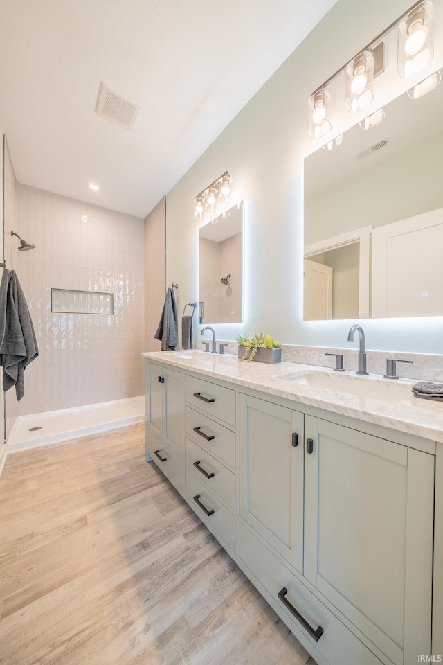 848 W S St, Upland, IN 46989 - bathroom featuring double vanity, wood finished floors, and tiled shower