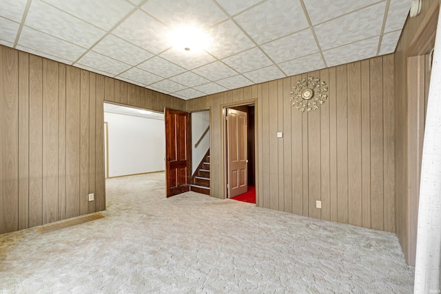 1202 S Van Buren St, Auburn, IN 46706 - carpeted empty room with stairway and wood walls
